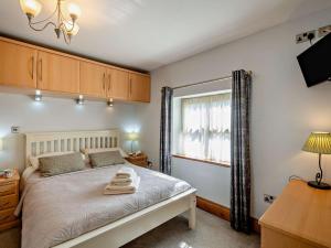 a bedroom with a bed with two towels on it at 3 Bed in Conwy oc-95906 in Conwy