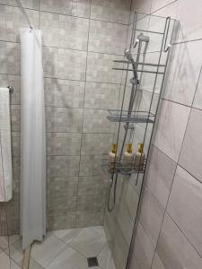 a bathroom with a shower with a glass door at Kabakum See infinity in Varna City