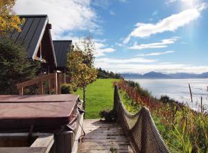 a path leading up to a house with a fence at Alaskan Suites in Homer