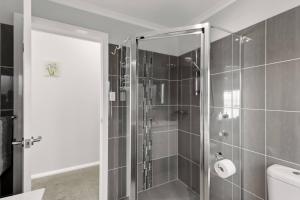 a shower with a glass door in a bathroom at Scenic Shores in Budgewoi +17 photos