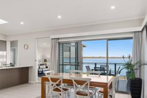 a dining room with a view of the ocean at Scenic Shores in Budgewoi
