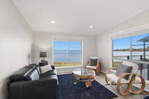 a living room with a couch and a table at Scenic Shores in Budgewoi