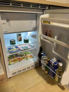 an open refrigerator with food and drinks in it at Babsi Appartments - leben am Land in Wels