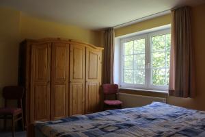 a bedroom with a bed and a large window at Steenshof in Heringsdorf +11 photos
