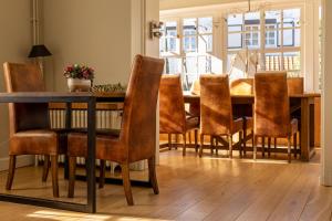a dining room with a wooden table and chairs at B&B Dreamcottage in Knokke-Heist