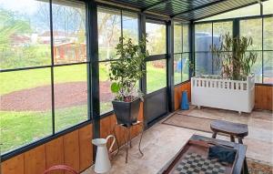 a greenhouse with two potted plants in it at Awesome Home In Charritte-De-Bas With Wifi in Charritte-de-Bas