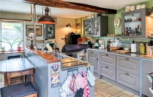 a kitchen with gray cabinets and a counter top at Awesome Home In Charritte-De-Bas With Wifi in Charritte-de-Bas