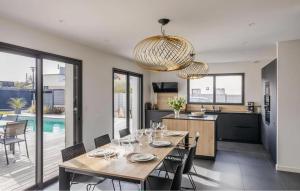 a dining room and kitchen with a table and chairs at Villa Botero Dinard in Dinard