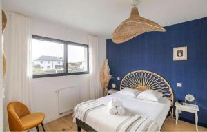 a bedroom with a bed and a blue wall at Villa Botero Dinard in Dinard