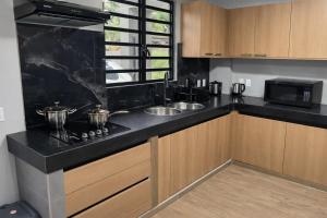a kitchen with a sink and a counter top at Southgate Residence in Paramaribo +3 photos