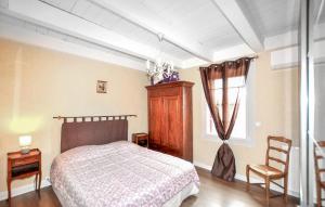 a bedroom with a bed and a window at Authentique Maison Piscine in Saint-Amans-Valtoret