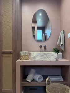 a bathroom with a sink and a mirror at A Casa Di Zoi in Archangelos +22 photos