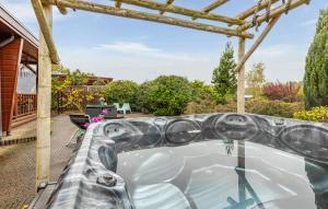 a hot tub on the patio of a house at Nice Home In Erm With Wifi in Erm