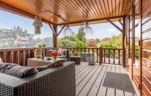 a patio with a couch and a table on a deck at Nice Home In Erm With Wifi in Erm +18 photos