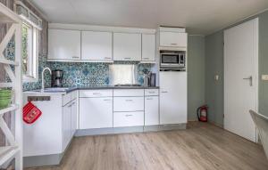 a kitchen with white cabinets and white appliances at Nice Home In Erm With Wifi in Erm