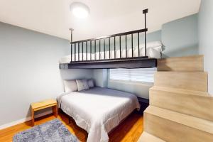 a small bedroom with a bunk bed and a staircase at The Adventure Pad, Unit 1 in Branson +21 photos