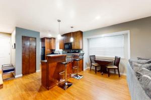 a kitchen and living room with a table and chairs at The Adventure Pad, Unit 1 in Branson