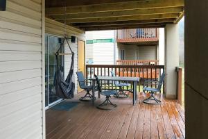 a porch with a hammock and a table and chairs at The Adventure Pad, Unit 1 in Branson