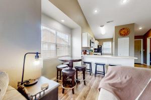a living room with a table and a kitchen at Lake Adventures at Eagle's Nest in Branson