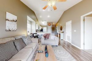 a living room with a couch and a ceiling fan at Lake Adventures at Eagle's Nest in Branson