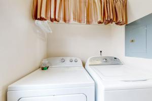 a laundry room with a washer and dryer at Lake Adventures at Eagle's Nest in Branson +24 photos