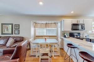 a kitchen and living room with a couch and a table at Treetop Tranquility in Branson