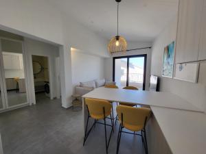 a kitchen and living room with a table and chairs at Sea Star in Žman