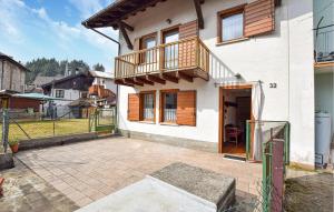 a white house with a balcony and a patio at Ca' Piero in Lamon