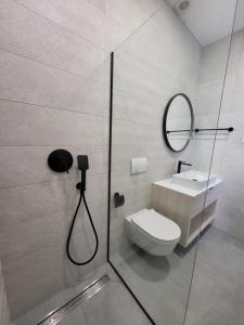 a bathroom with a shower and a toilet and a mirror at Sea Star in Žman