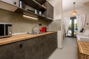 a kitchen with a sink and a microwave at The Old Port in Limenas
