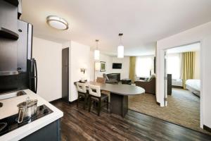 a kitchen and living room in a hotel room at Candlewood Suites Cheyenne by IHG in Cheyenne