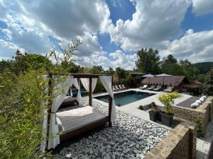 a backyard with a swimming pool with a swing and a fence at GardenLux Vrdnik in Vrdnik