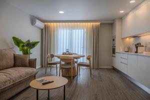 a living room with a couch and a table at Azor Signature Flats - III in Ponta Delgada
