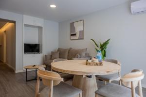 a living room with a table and a couch at Azor Signature Flats - III in Ponta Delgada
