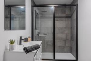 a bathroom with a shower and a sink at Azor Signature Flats - III in Ponta Delgada +11 photos