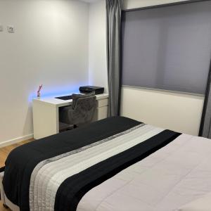 a bedroom with a bed with a desk and a window at T1 Luxgarden in Lamego +25 photos