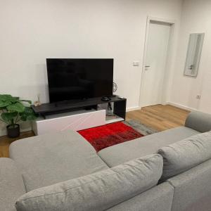 a living room with a couch and a flat screen tv at T1 Luxgarden in Lamego