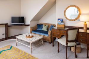 a living room with a desk and a chair at The Moorings Hotel & Restaurant in Gorey
