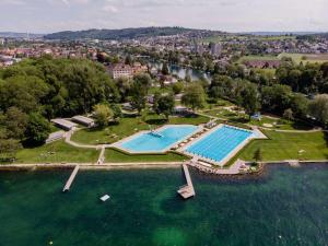 an aerial view of a large swimming pool in the water at Lake apartment with terrace in Nidau