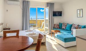 a living room with a couch and a table at Open Sea Apartments in Utjeha