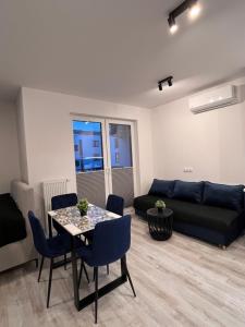 a living room with a table and a couch at Apartament Raj in Biała Podlaska +12 photos