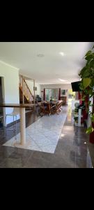 a living room with a table and chairs and a staircase at Hostel francis in Tristán Suárez
