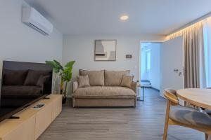 a living room with a couch and a table at Azor Signature Flats - IV in Ponta Delgada