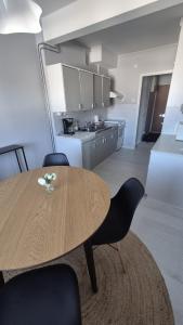 a dining room table with chairs and a kitchen at Apartments at Koulukatu in Savonlinna +12 photos