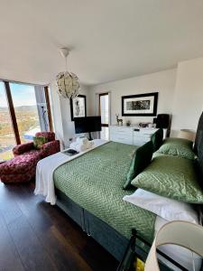 a bedroom with a large bed and a chair at James Clow Boutique Bed & Breakfast in Belfast
