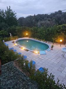 a large swimming pool with lights in a yard at Rose apartment nr1 Mesongi in Mesongi