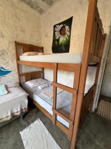 a couple of bunk beds in a room at Hostel Flor da Vida in Canoa Quebrada