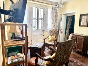 a living room with a tv and a chair at Maison Luard in Bedous