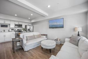 a living room with a couch and a table at Steps to Dome Breathtaking views parking AC! in Tacoma