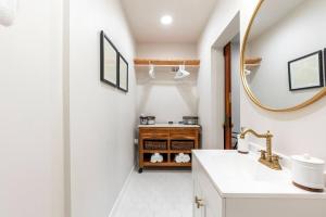 a bathroom with a sink and a mirror at 6th Ave district studio Quiet Prkng in Tacoma